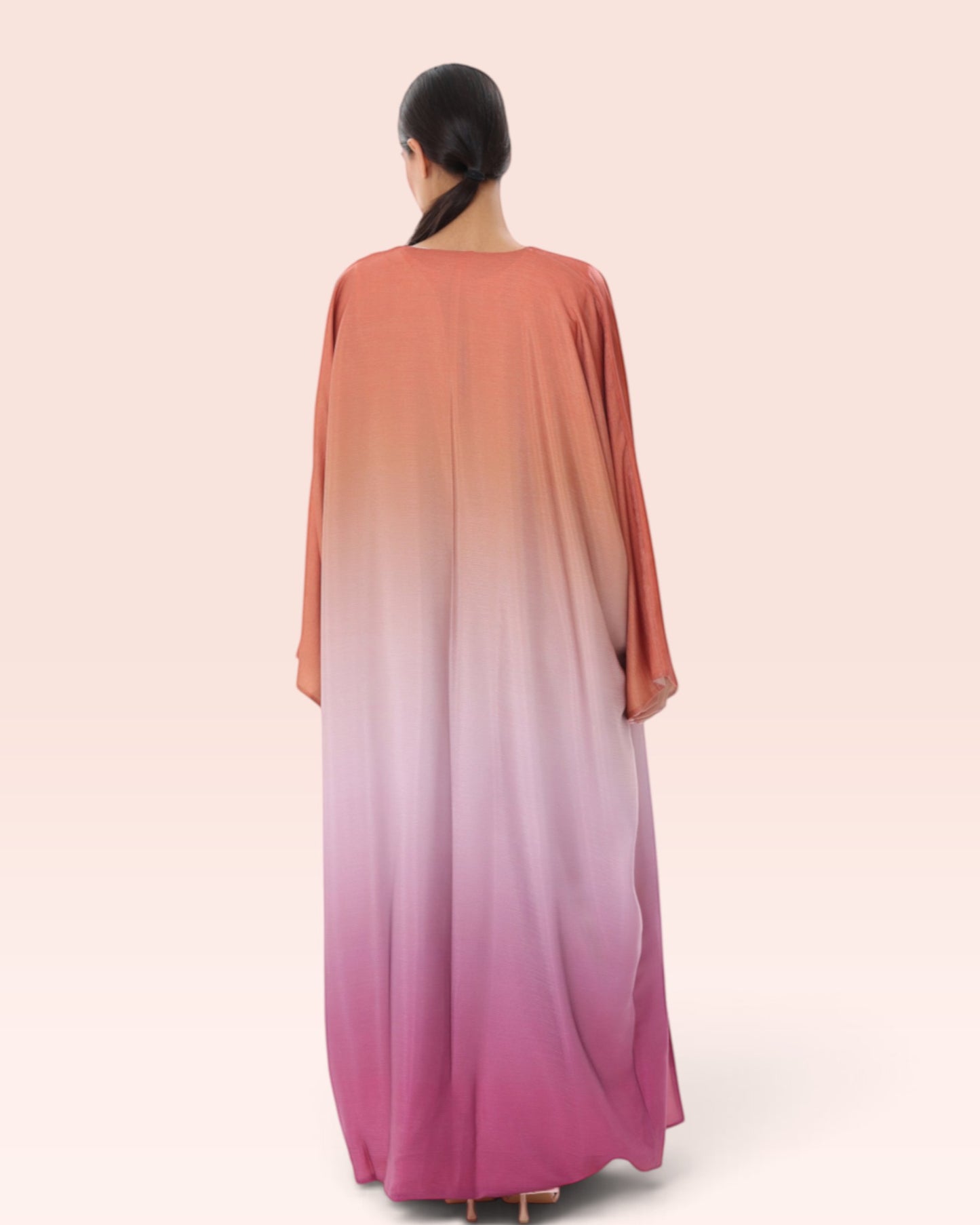Amore Abaya Boutique Sunset Ombre Bisht Abaya featuring a flowy, lightweight design in orange to pink gradient.