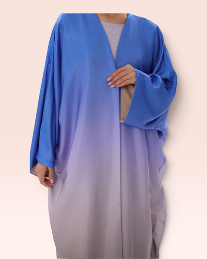 Amore Abaya Boutique Sunset Ombre Bisht Abaya featuring a flowy blue to grey gradient design in lightweight fabric.