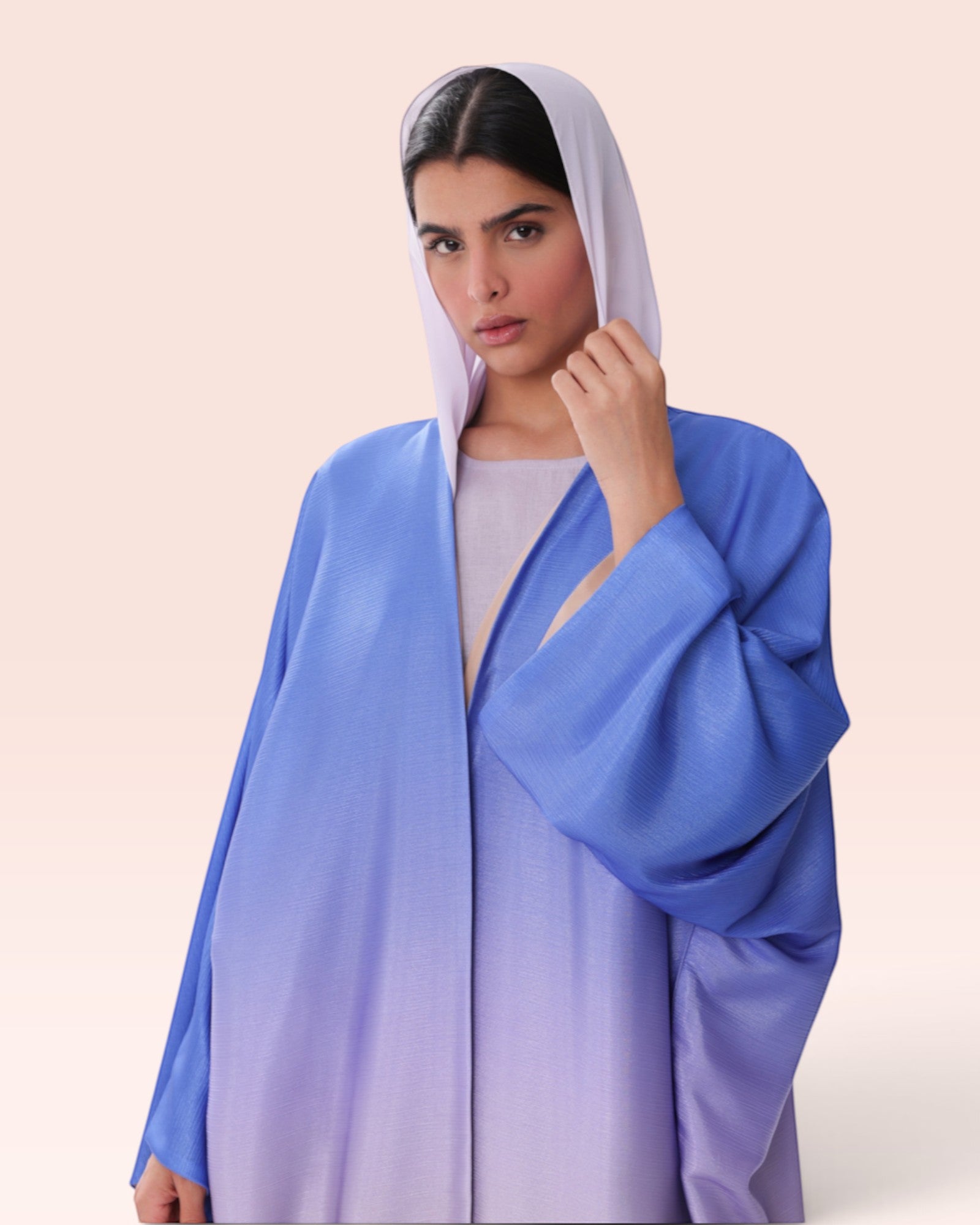 Amore Abaya Boutique Sunset Ombre Bisht Abaya in blue and purple gradient fabric with a hood on a model