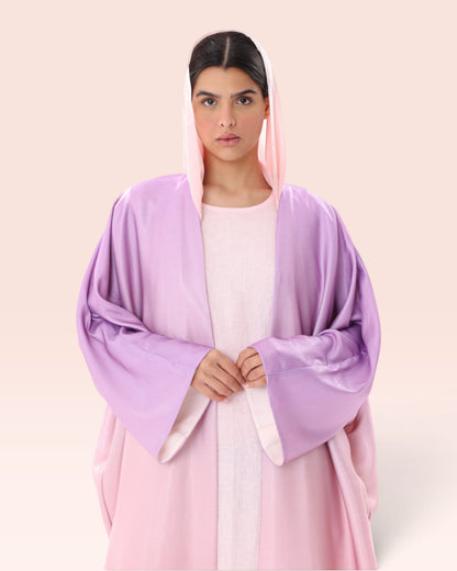 Amore Abaya Boutique Sunset Ombre Bisht Abaya in soft pink and purple, featuring a lightweight, flowy draped design.